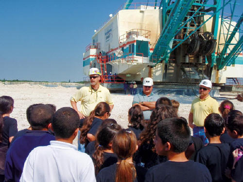 Community relations are important at White Rock Quarries in Miami, FL, which hosts field trips for area schools and other organizations with its mining contractor, North American Mining Corp. Here, NAMCs Ed Barnett and Hubie Perez, and WRQs Ronnie VanLandinham lead a tour. (Photos by Linda Maddy)